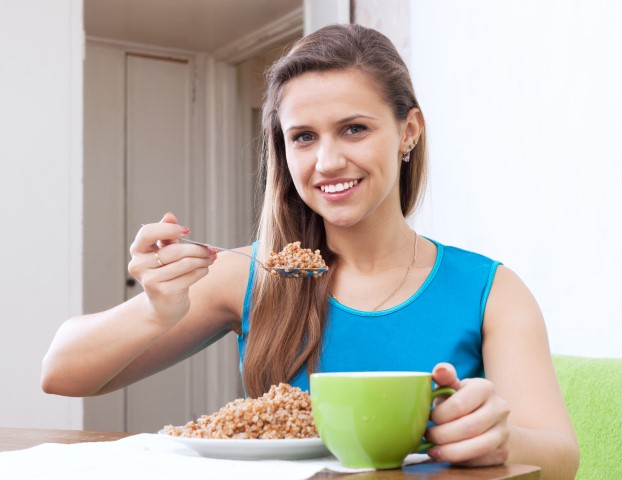 a women eating hemp food ina cup