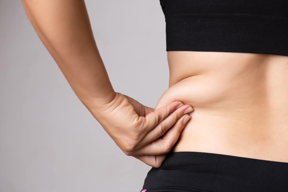a women check her waist after weight loss surgery